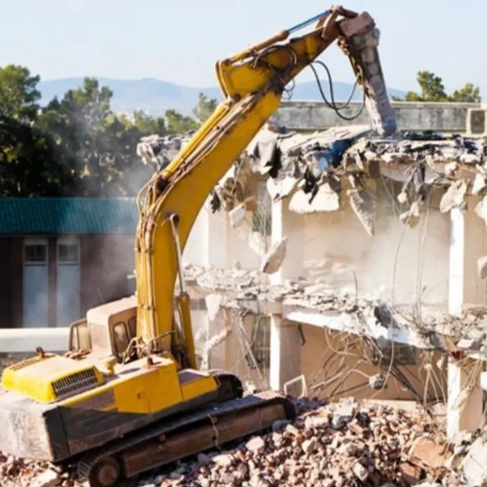 Excavadora realizando demolición residencial